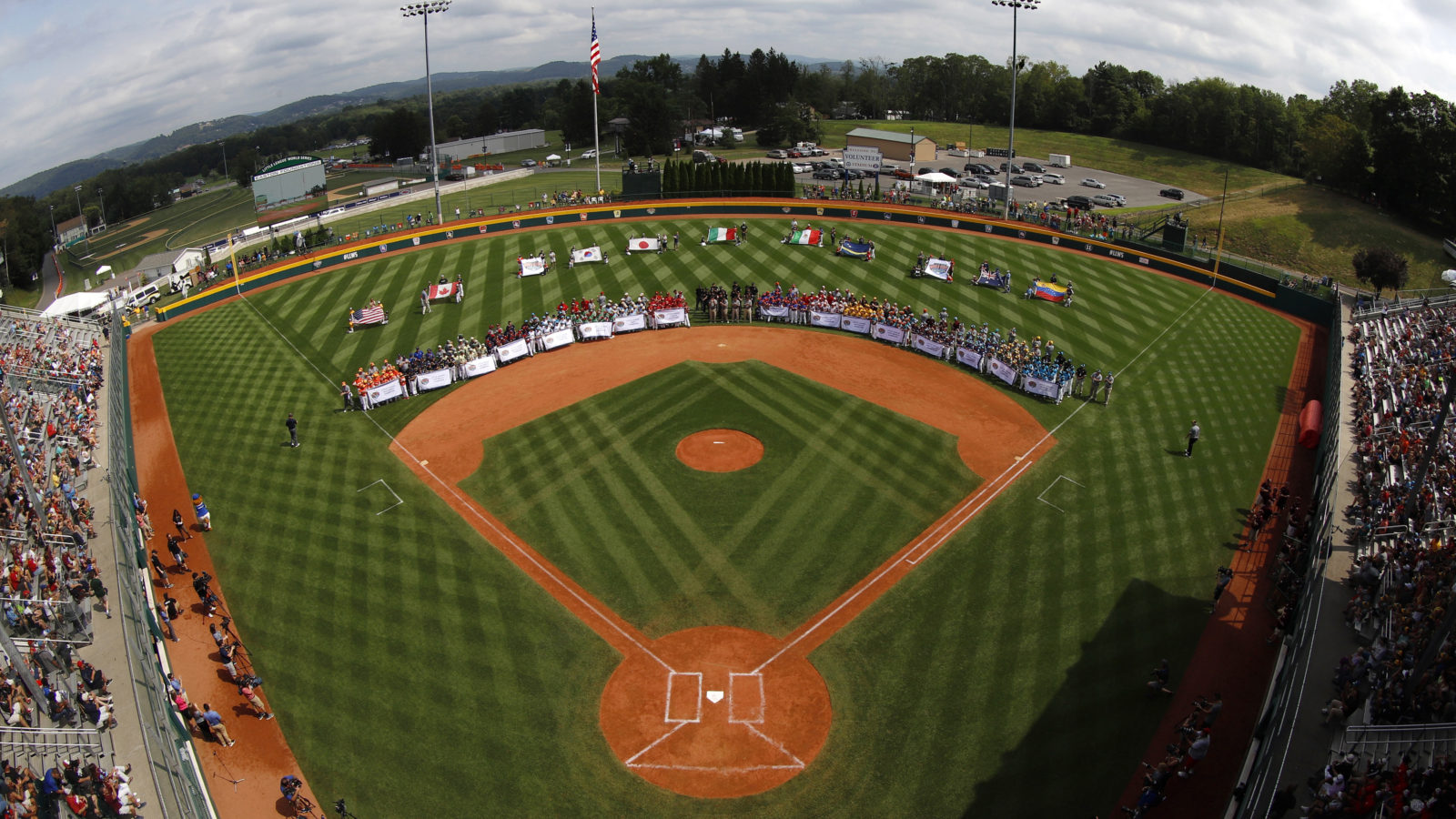 The 16 Little League Regional Champions ring the infield of Volunteer Stadium during the opening ceremony of the 2019 Little League World Series tournament in South Williamsport, Pa.,Thursday, Aug. 15, 2019. (AP Photo/Gene J. Puskar)